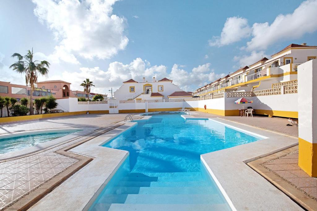 a swimming pool in the middle of a building at Casa sam in Caleta De Fuste