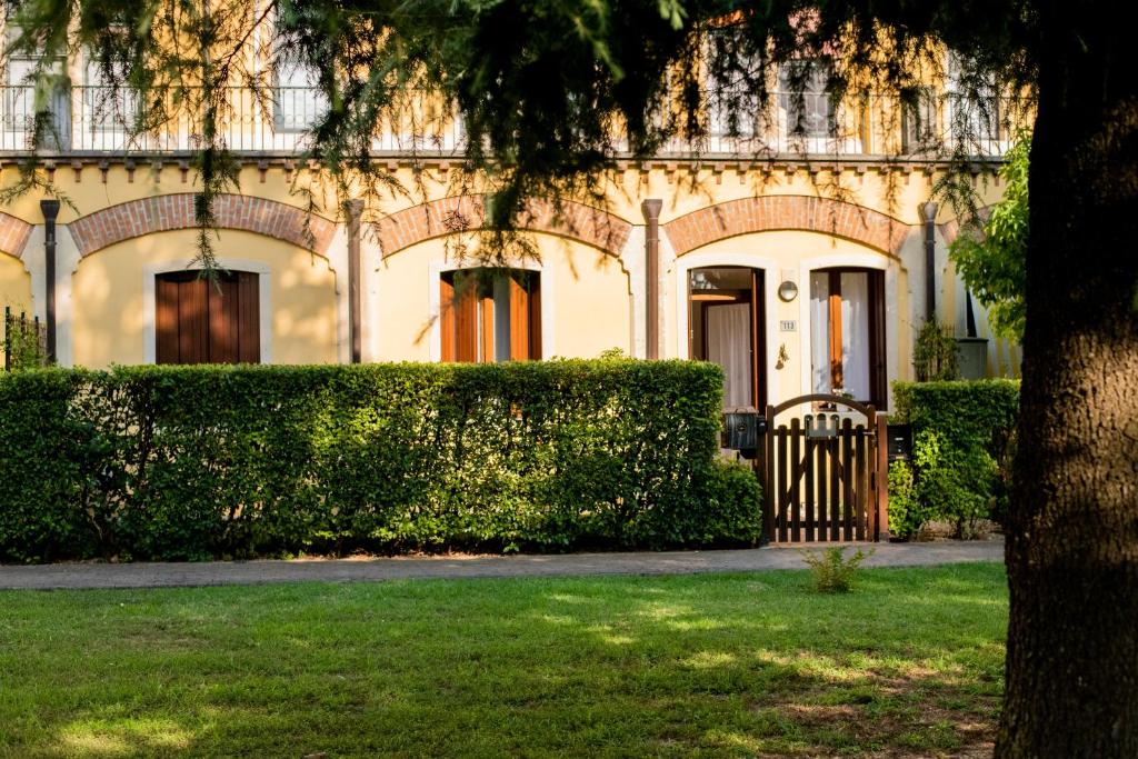 a building with a gate in front of a yard at Dream Room Apartment in Illasi
