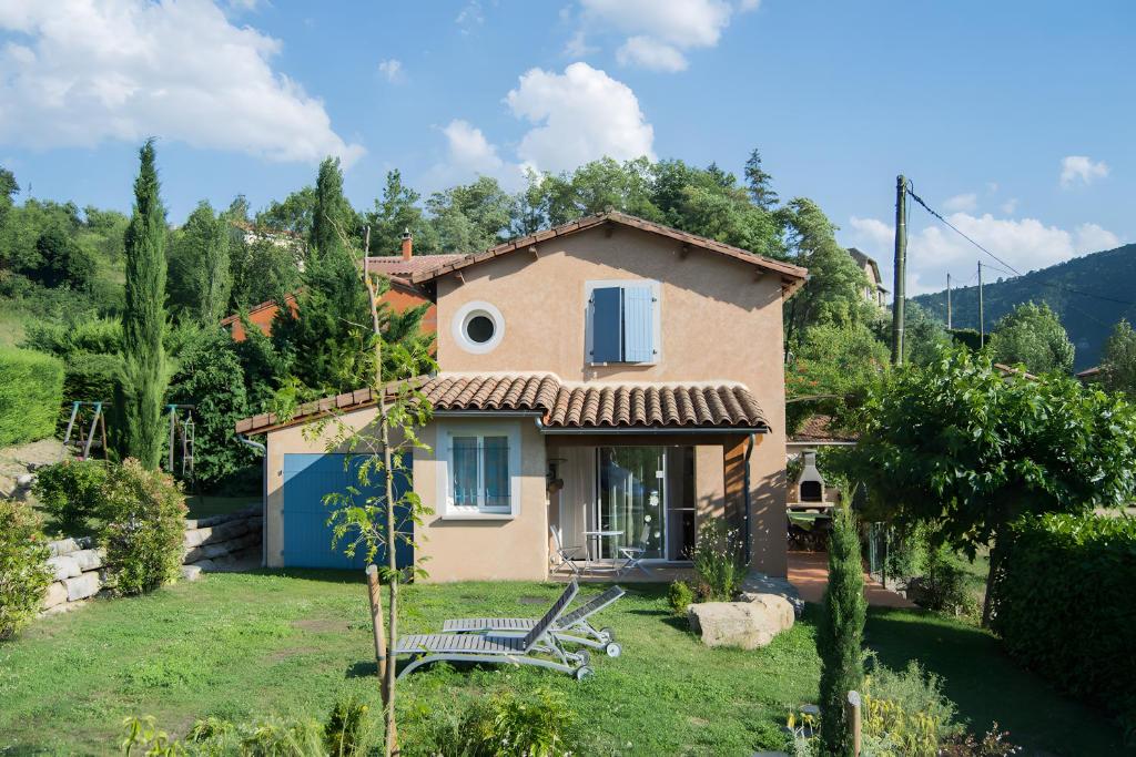 a small house with a bench in a yard at Gite Le Calcadis in Mostuéjouls