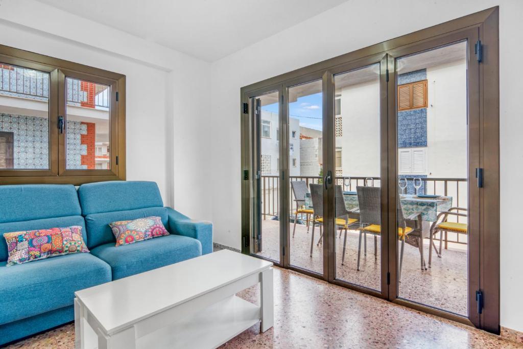 a living room with a blue couch and a table at Brooklyn in Oliva