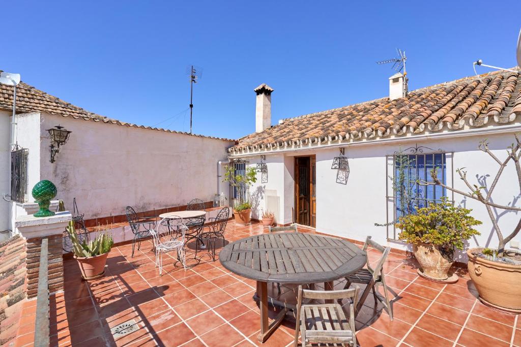 a patio with a table and chairs on a house at Villa Carlitos in Comares