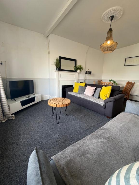 a living room with a couch and a table at Central location location in Hollington