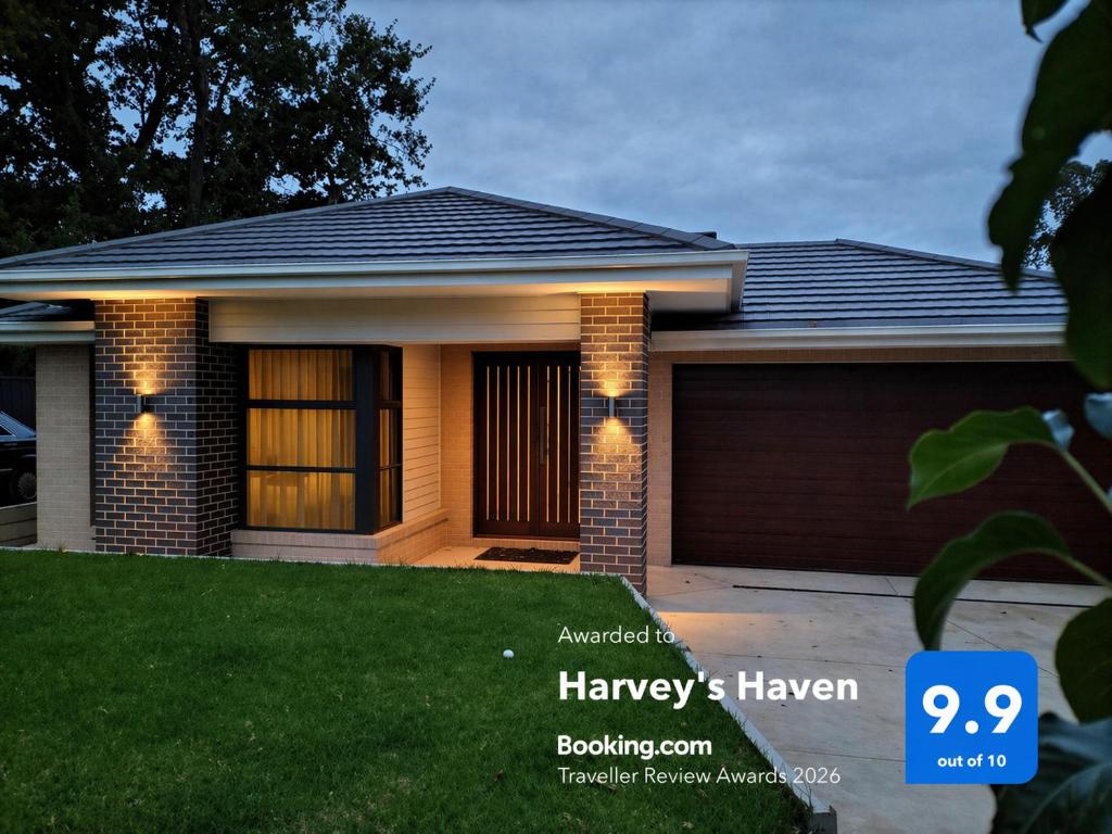 a house with a sign that reads room at Harvey's Haven in Castlemaine