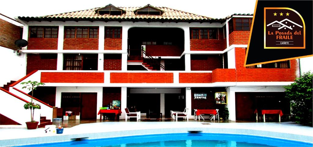 a building with a swimming pool in front of it at La Posada del Frayle in El Chilcal