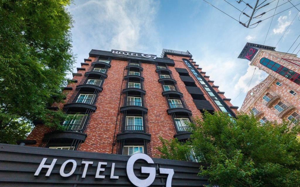 a hotel g on top of a red brick building at Iksan Hotel G7 in Songman