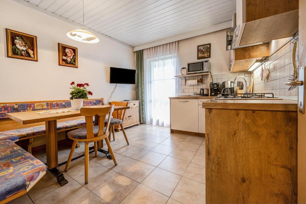 a kitchen with a table and a dining room at Apartment Sonnenschein in Mühlbach
