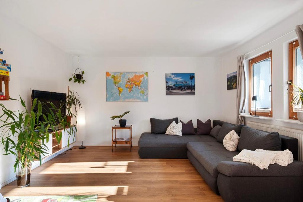 a living room with a couch and a table at Ruhige Schwarzwald Ferienwohnung in Buchenbach