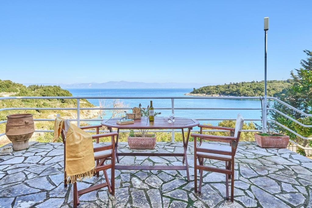 a patio with a table and chairs and the ocean at Dolphin studio in Gaios