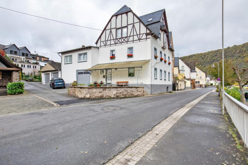 a white building on the side of a street at Pension Mosellablick in Briedern