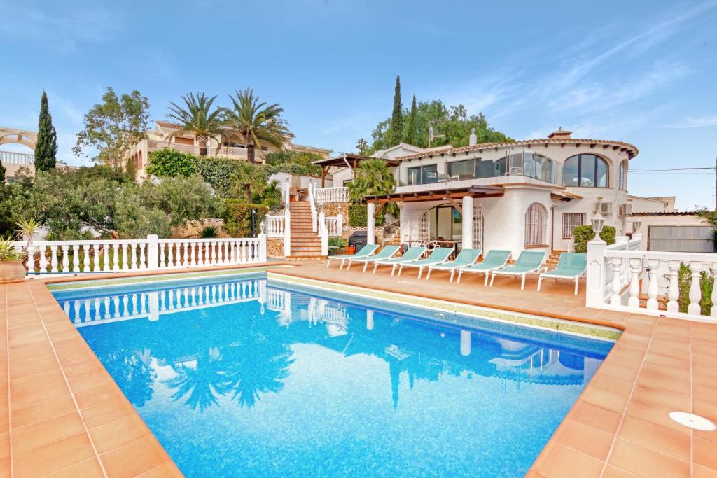 a house with a swimming pool in front of a house at Ericito in Denia