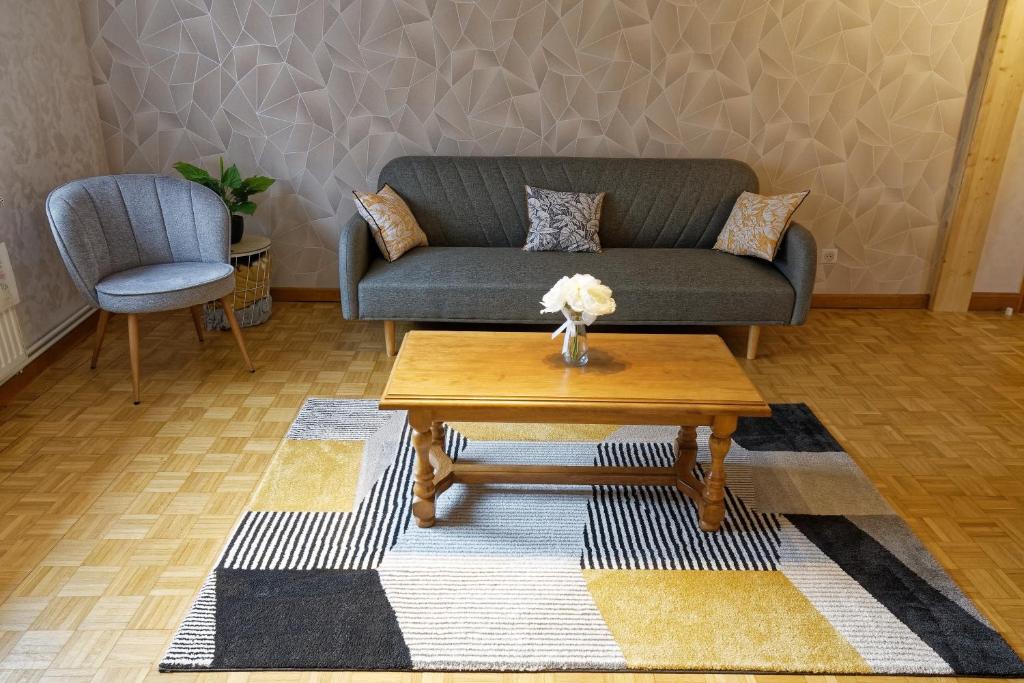a living room with a couch and a coffee table at Chez Jeanne, charmante maison in Dossenheim-sur-Zinsel