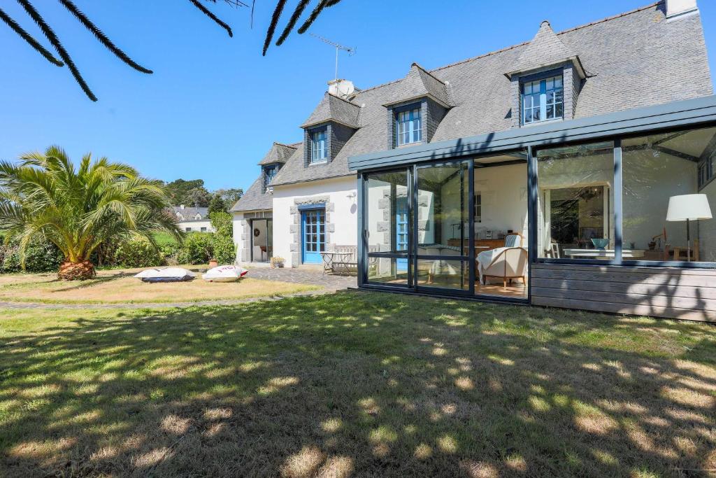 an exterior view of a house with large glass doors at L'hermine - Villa de charme in Locquirec