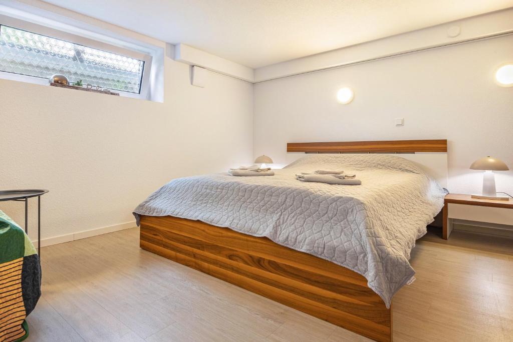 a bedroom with a bed and a window at Tulip Path 3 in Melle