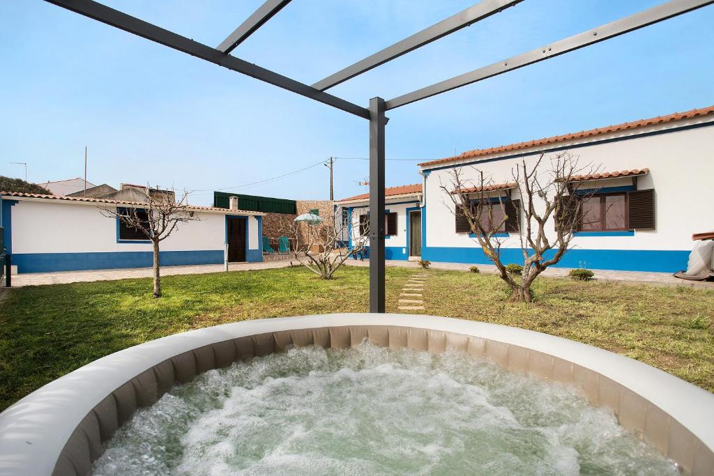 a hot tub in the backyard of a house at Bouros's Cliff in Serra do Bouro