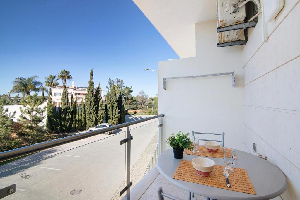 a table on a balcony with a view of a street at Casa Monte da Balaia in Olhos de Água