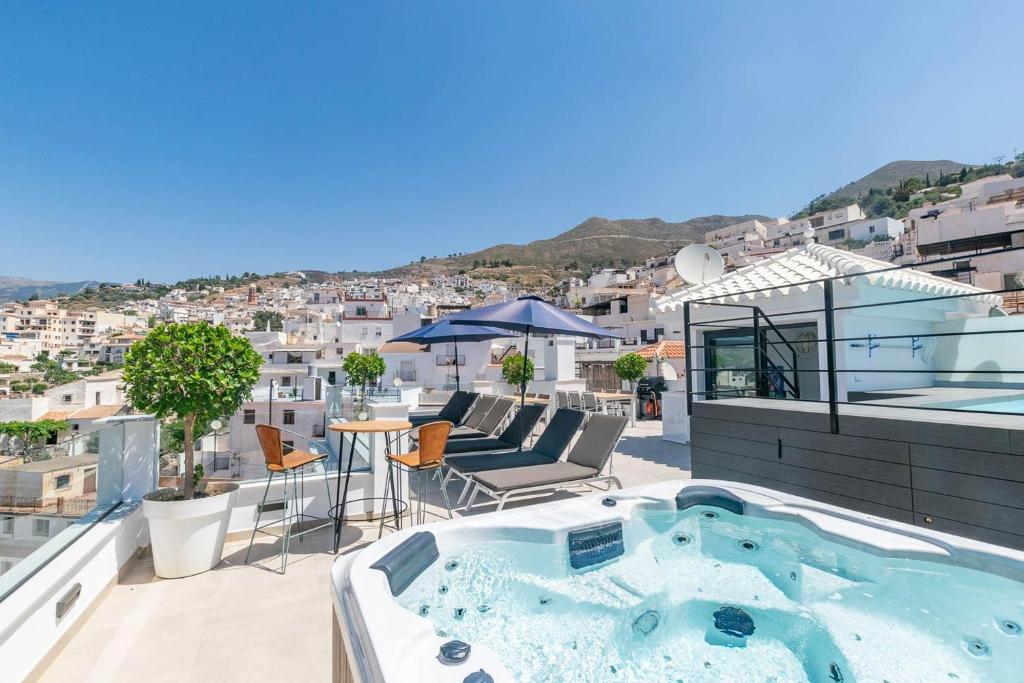 a hot tub on the roof of a house at Modern Apartment in Cómpeta I in Cómpeta