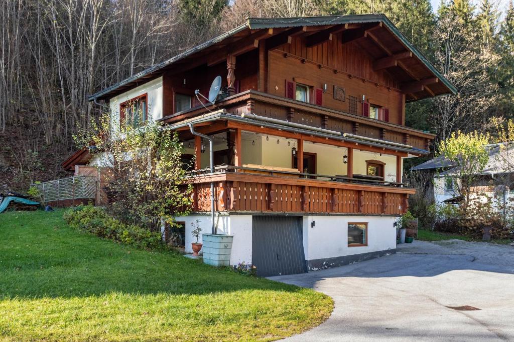 a large house with a gambrel roof at Ferienwohnung Petra Top 3 in Kössen