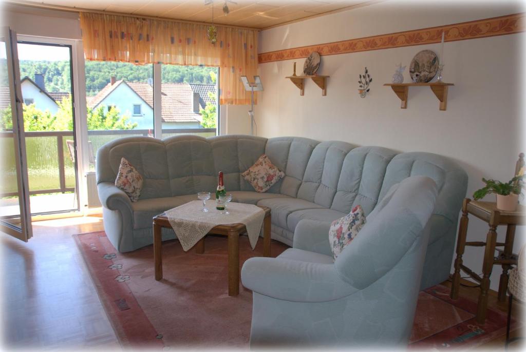 a living room with a blue couch and a table at Ferienwohnung Gabi in Borken