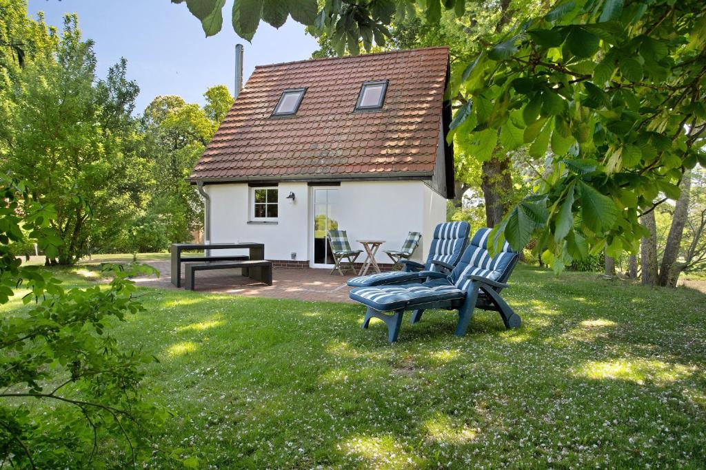 a couple of chairs in front of a small house at Ferienhaus Kitzklause in Walkendorf