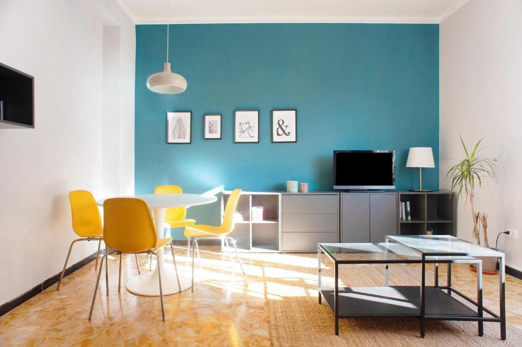 a living room with a table and yellow chairs at Casa Caterina in Levanto