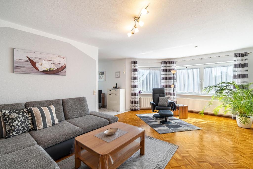 a living room with a couch and a chair at Ferienwohnung 'Kraichgau-Nest' in Reichartshausen