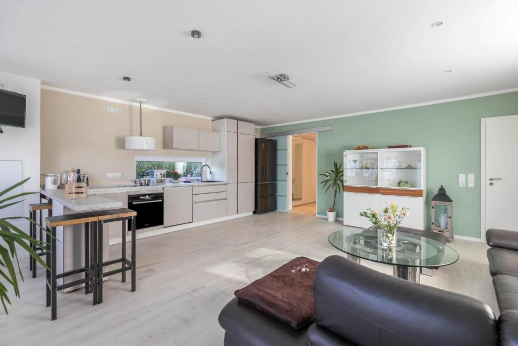 a kitchen and living room with a couch and a table at Wohnung Deluxe in Heide