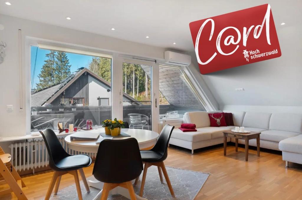 a living room with a cocacola sign on the wall at Ferienwohnung Hirschsprung Saig in Lenzkirch