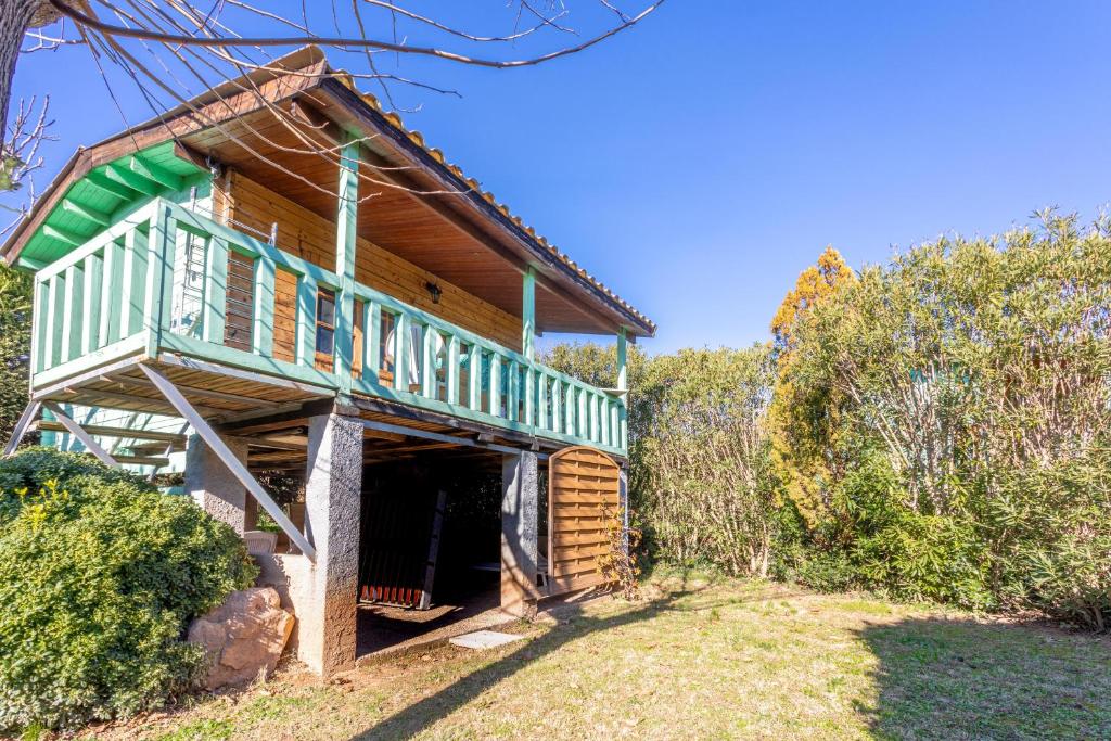 a wooden house with a balcony on top of it at Joli Chalet en bois mésange bleu in Roquebrune-sur-Argens