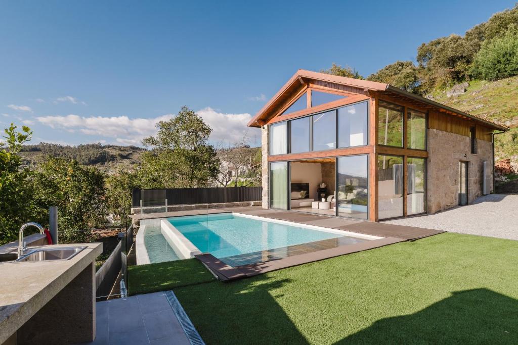 a house with a swimming pool in the yard at Dunas e Abraços in Braga