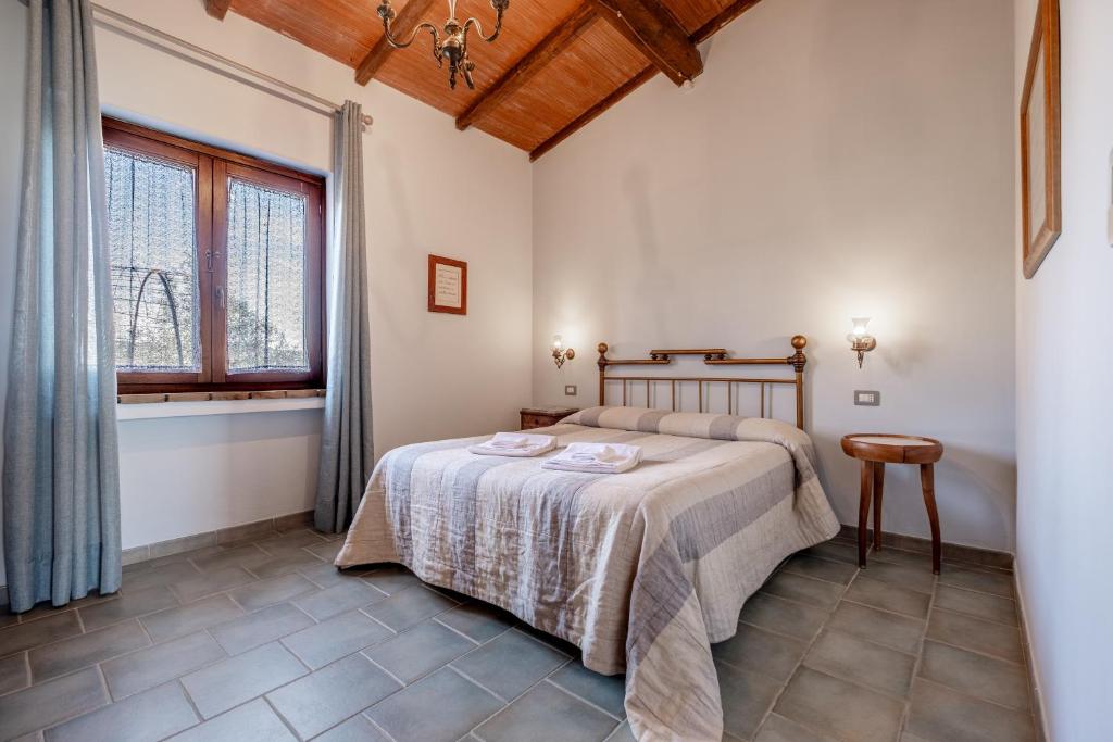a bedroom with a bed and a window at La Svolta - Aria in Manciano
