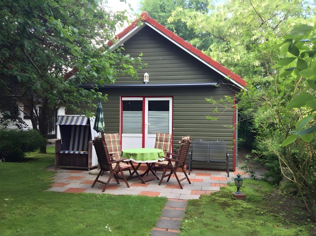 a picnic table and chairs in front of a cabin at Ferienhaus Loubier Marne in Marne