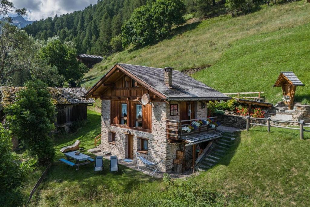 a small house on top of a hill at Baita Mas Sternai Nel Parco in Bagni di Rabbi