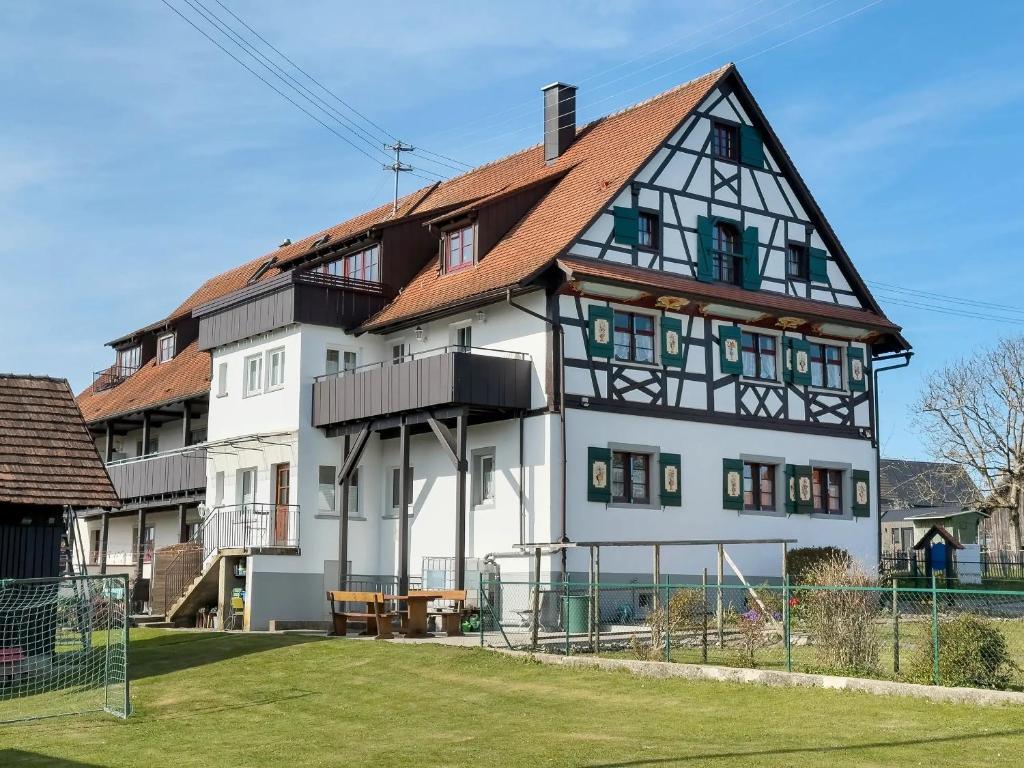 a large white house with a red roof at Haus Hilebrand in Kressbronn am Bodensee