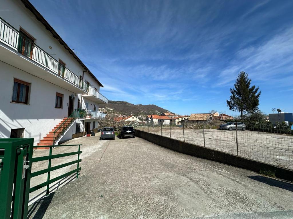 a building with two cars parked next to a fence at Zio Gennaro Residence in Agerola