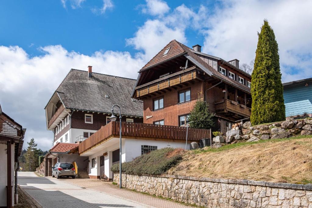 a house on top of a hill next to a street at Rathäusle in Titisee-Neustadt