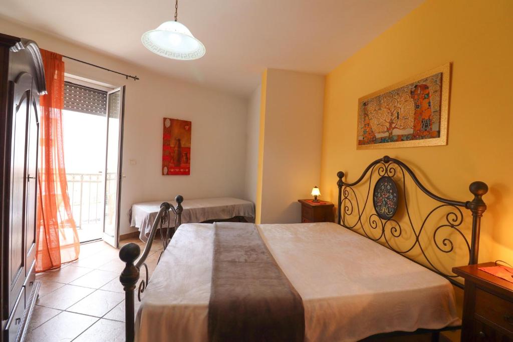 a bedroom with a large bed and a window at Casa Samira a Otranto in Otranto