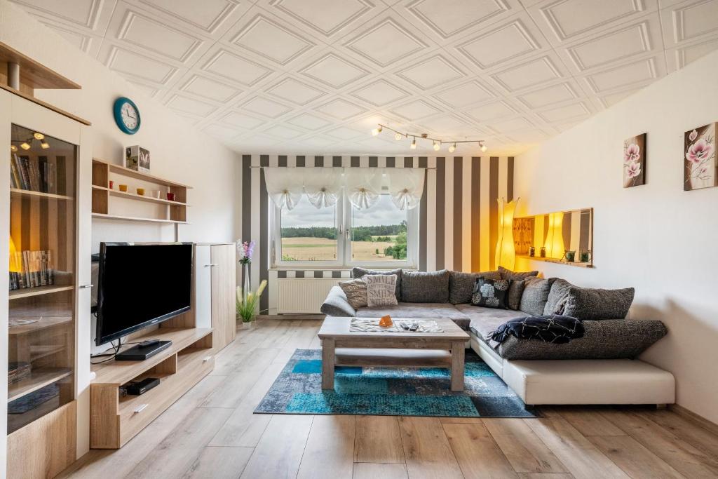 a living room with a couch and a tv at Familie Heiko Schroth in Neußen