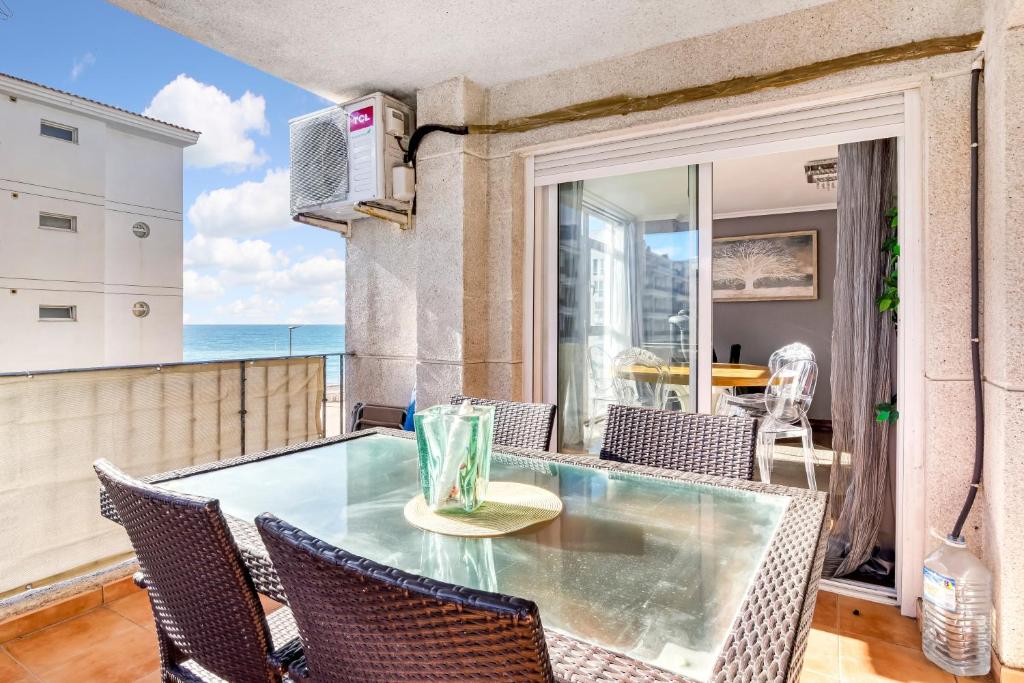 a dining room with a glass table and chairs at Altea Beach in Altea