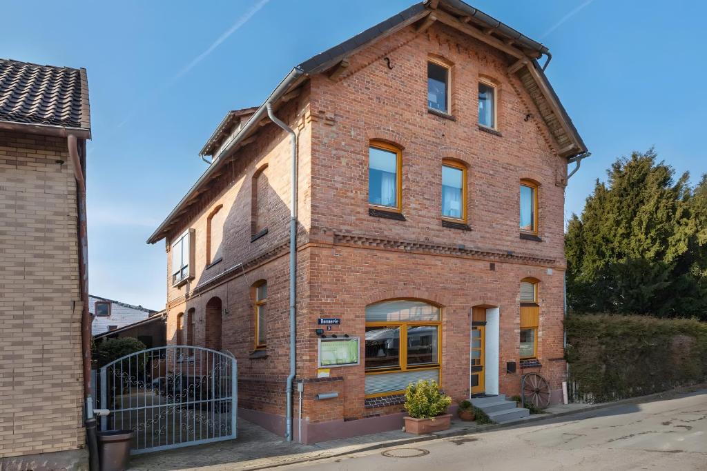an old brick building on a street at Pension Schlachter's Hius in Algermissen