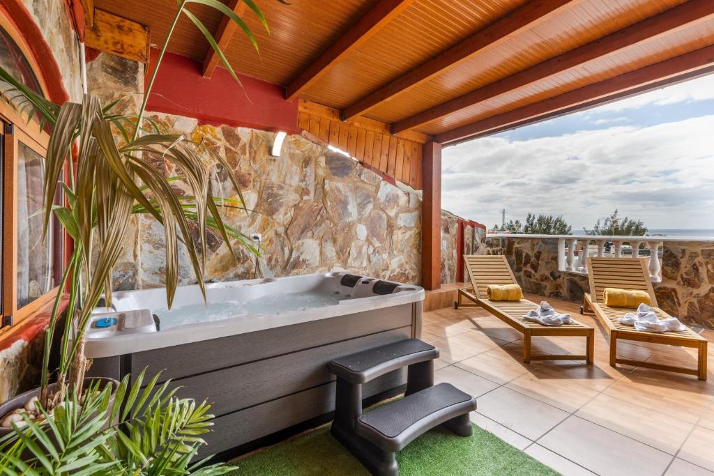 a bathroom with a bath tub on a patio at Chabela's Penthouse in Lajita