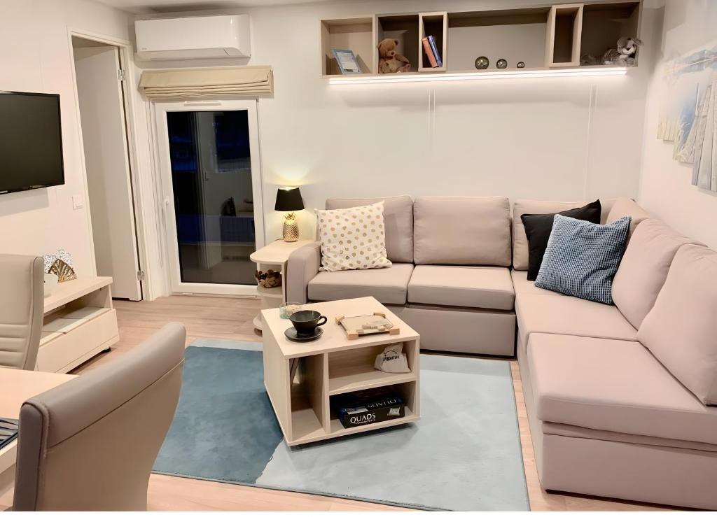 a living room with a couch and a table at Domaine 3016 in Roquebrune-sur-Argens
