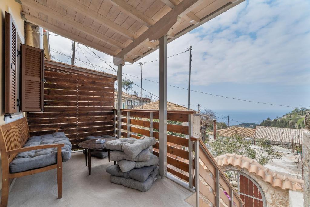 a patio with a table and chairs on a balcony at Maniaveta's House in Exanthia