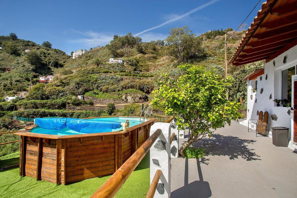 a hot tub on the side of a house at Casa Cueva in Teror
