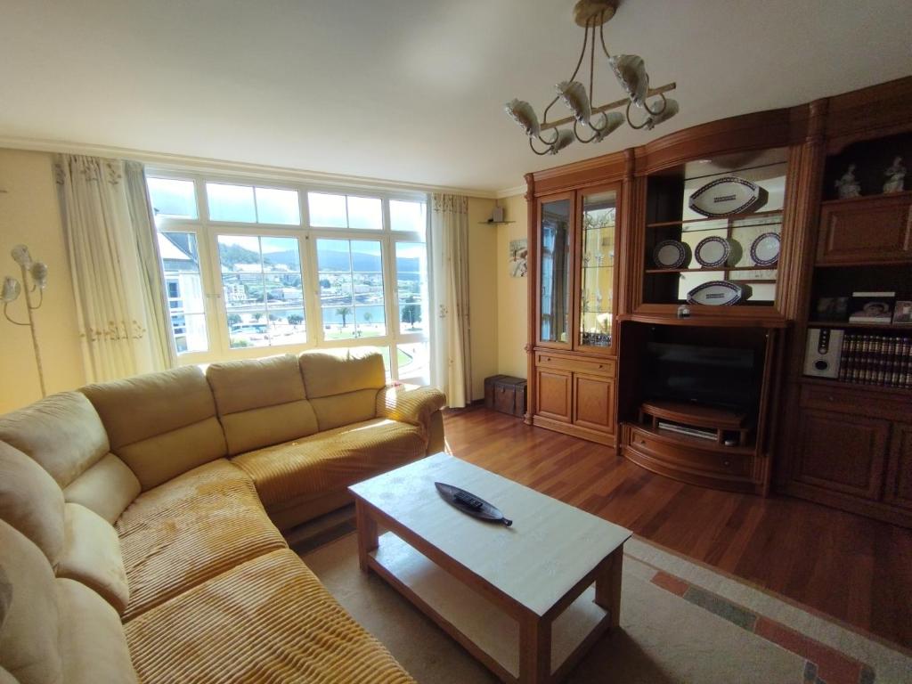 a living room with a couch and a coffee table at O Son in Cee