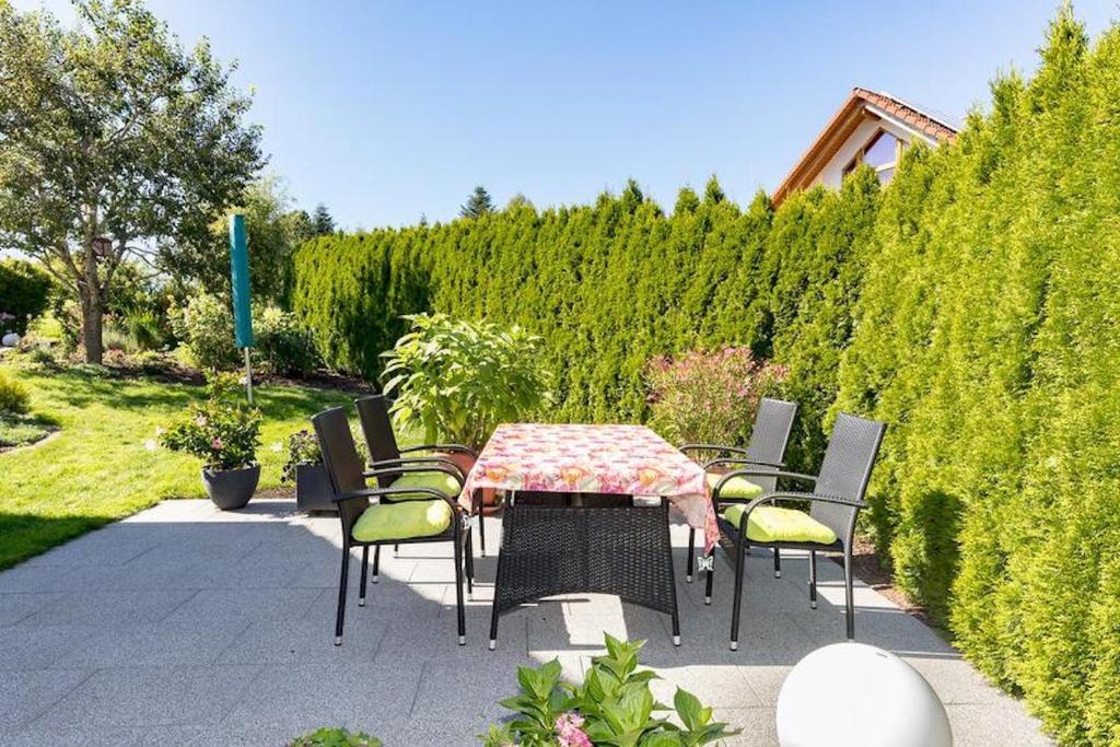 a table and chairs sitting on a patio at Ferienwohnung Lauser Ug in Herdwangen-Schönach