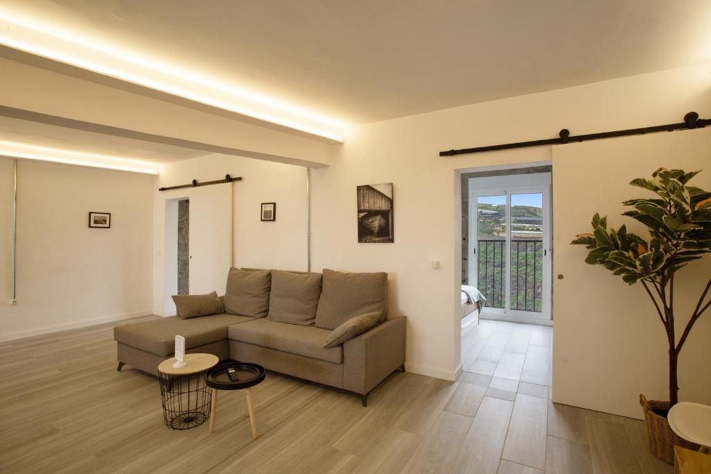 a living room with a couch and a table at El Alpendre in Moya