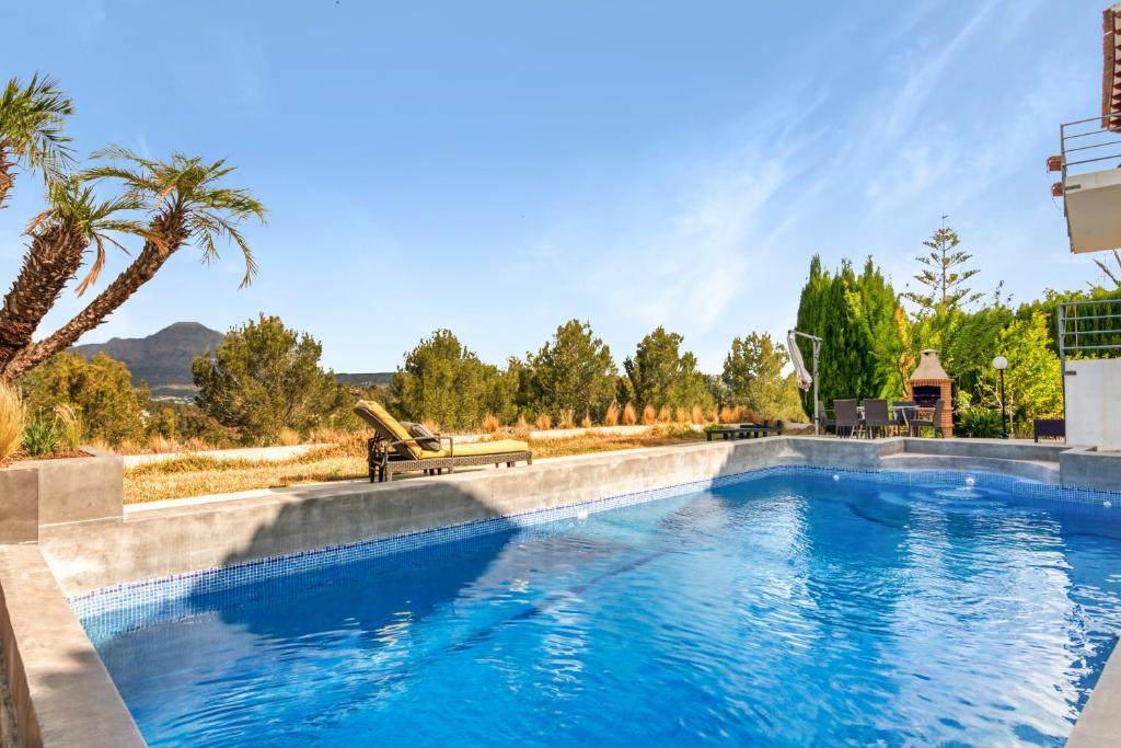 a swimming pool in the middle of a yard at Bohemia in Jávea