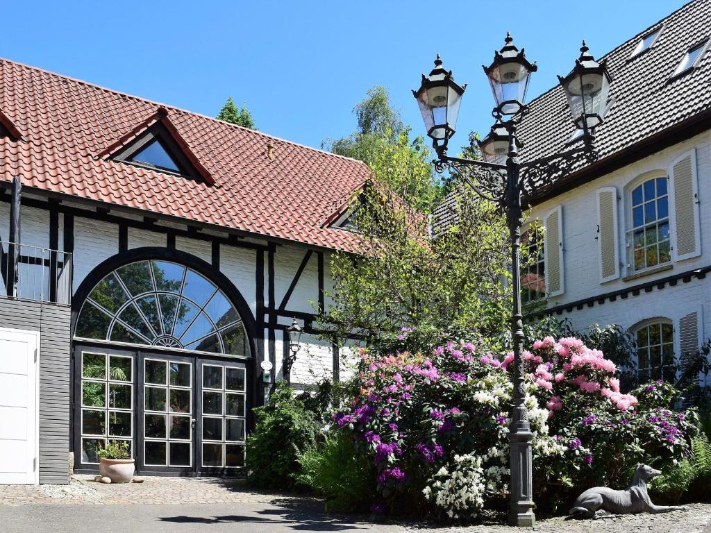 a street light in front of a house with flowers at Landhaus Bornemann in Diemelsee