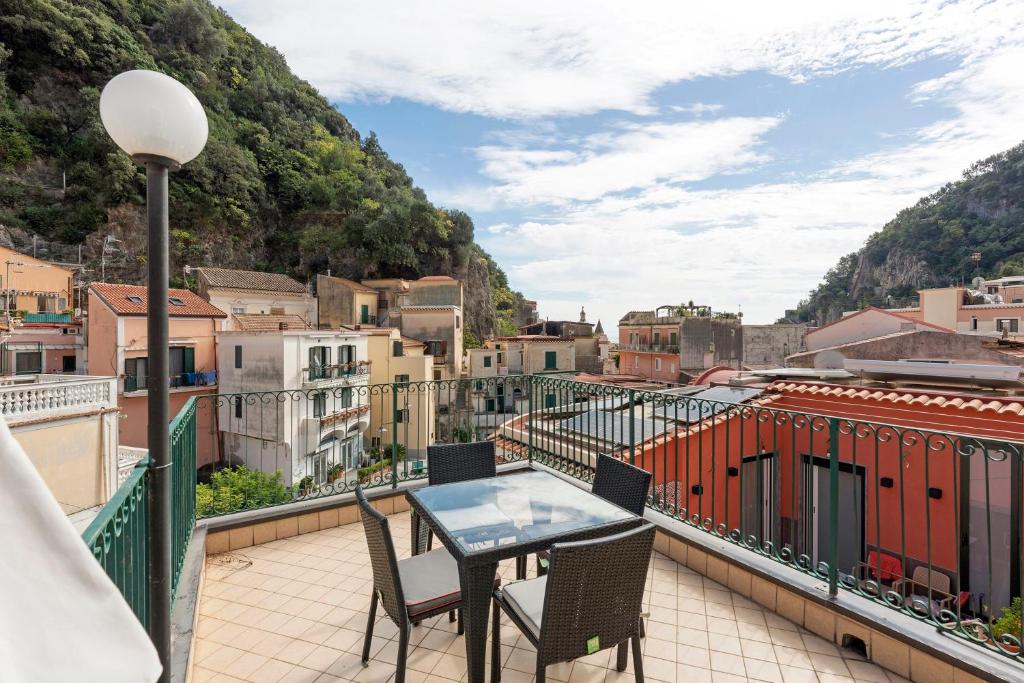 a patio with a table and chairs on a balcony at Ce Tour - Casa Cetara Centro 1 in Cetara