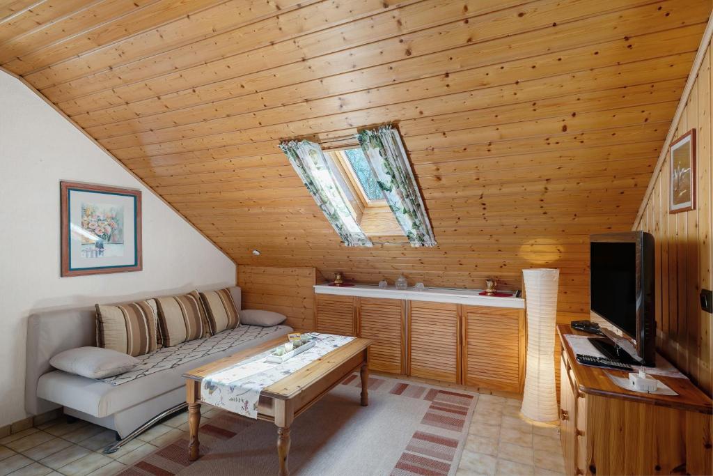 a living room with a couch and a tv at Stoffel in Darstein